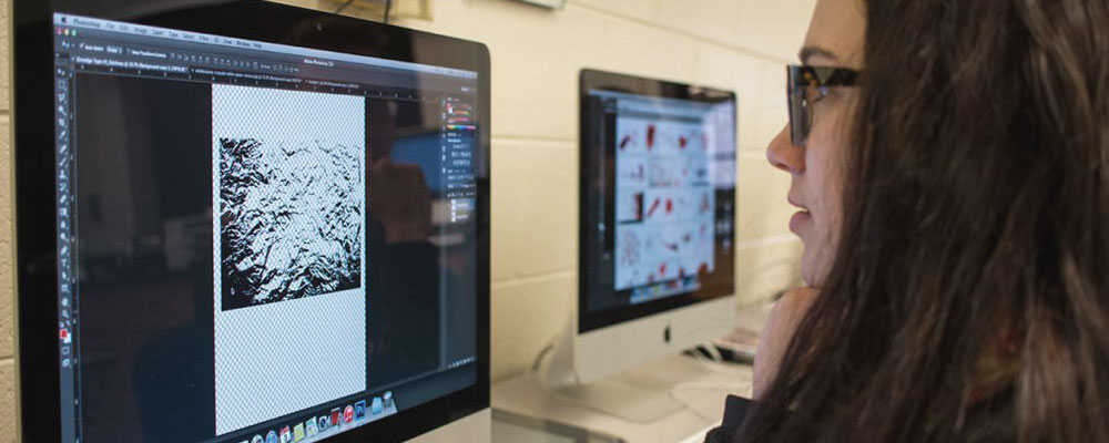 ICC Multimedia student working in Photoshop during class.